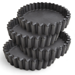 Set of four 4-inch round Aspire Bakeware tart pans stacked on top of each other