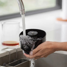 Rinsing VacOne brewer head under kitchen tap