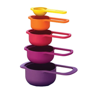 Joseph Joseph Nest Measuring Cups, hovering above one another in order