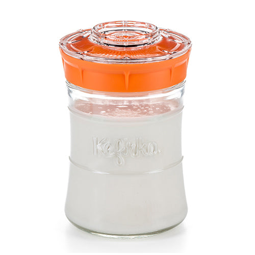 Kefirko jar with orange lid and prepared kefir inside
