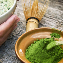 Making matcha tea with a bowl and whisk