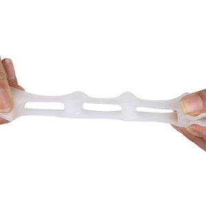 stretching a Flexible Silicone Toe Spreader to elongate the middle 3 holes
