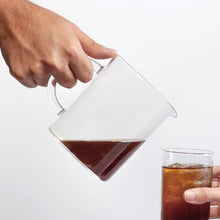 Pouring finished cold brew from VacOne Carafe